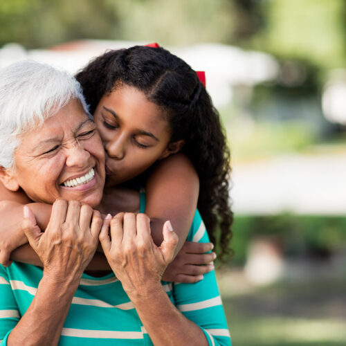 Older woman with granddaughter smiling