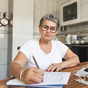 A woman filling out an application to medi-cal