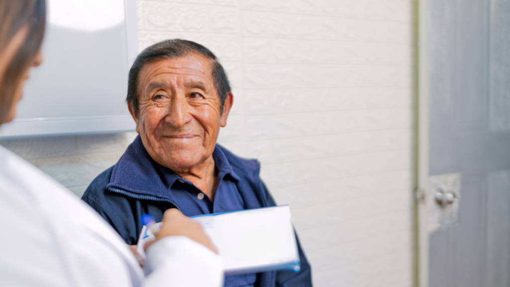 Older man smiling at doctor's office.