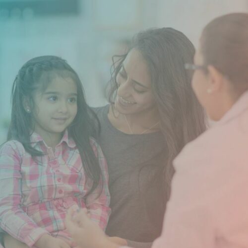 Mother and young daughter speak with their doctor